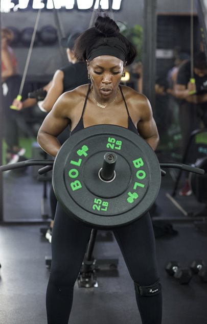 an athlete adding weight to their barbell
